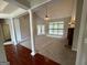 A spacious living room features hardwood and carpet floors, pillars, fireplace, and large windows at 237 Shockley Way, Dallas, GA 30157
