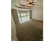 Spacious main bedroom with tray ceiling, ceiling fan, carpeted floors, and ample natural light at 237 Shockley Way, Dallas, GA 30157