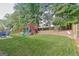 Backyard features a play structure, dining set, mature trees, and well-kept lawn at 4180 Pineset Dr, Alpharetta, GA 30022