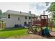 Backyard view with a home, play structure, and lush green grass at 4180 Pineset Dr, Alpharetta, GA 30022