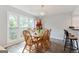 Bright dining room with wooden table, chairs, and a chandelier above at 4180 Pineset Dr, Alpharetta, GA 30022