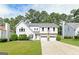 Charming two-story home featuring a two-car garage, landscaped yard, and a basketball hoop in the driveway at 4180 Pineset Dr, Alpharetta, GA 30022