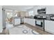 Bright kitchen featuring white cabinets, stainless steel appliances, granite countertops, and hardwood floors at 4180 Pineset Dr, Alpharetta, GA 30022
