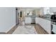 Bright kitchen featuring white cabinets, stainless steel appliances, granite countertops, and hardwood floors at 4180 Pineset Dr, Alpharetta, GA 30022