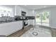 Bright kitchen with stainless steel appliances, white cabinets, and sliding glass doors leading to backyard at 4180 Pineset Dr, Alpharetta, GA 30022