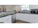 Bright kitchen featuring white cabinets, stainless steel appliances, granite countertops, and hardwood floors at 4180 Pineset Dr, Alpharetta, GA 30022