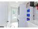 Laundry room with washer, dryer, shelving, and a window for natural light at 4180 Pineset Dr, Alpharetta, GA 30022