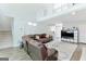 Open living room with hardwood floors, a stone fireplace, and lots of natural light at 4180 Pineset Dr, Alpharetta, GA 30022