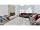Spacious living room with a stone fireplace, hardwood floors, and plush seating at 4180 Pineset Dr, Alpharetta, GA 30022