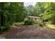 Exterior view of a single-story home with a wood ramp and lush landscaping at 400 Mccart Rd, Mcdonough, GA 30252