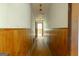 Long hallway with wood paneling on the lower portion of the wall and flooring at 400 Mccart Rd, Mcdonough, GA 30252