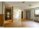 Open living space with wood floors, multiple windows and an interior hallway at 400 Mccart Rd, Mcdonough, GA 30252