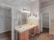 Bathroom with double sinks, wooden cabinets, and a large mirror at 424 Browning Field Way, Hampton, GA 30228
