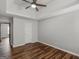 Primary bedroom with wood-look flooring, a ceiling fan, and tray ceiling at 424 Browning Field Way, Hampton, GA 30228