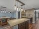 Open kitchen with an island, pendant lights, and views of the dining and Gathering room at 424 Browning Field Way, Hampton, GA 30228