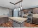 Updated kitchen featuring an island with stone countertops and stainless steel appliances at 424 Browning Field Way, Hampton, GA 30228