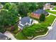 Aerial view of beautiful home surrounded by manicured lawns and mature trees at 5833 Wembley Dr, Douglasville, GA 30135