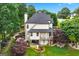 Aerial view of backyard with patio, garden beds, deck, and lush green lawn at 5833 Wembley Dr, Douglasville, GA 30135