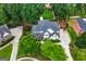 An aerial view of a stately home surrounded by lush greenery and mature trees at 5833 Wembley Dr, Douglasville, GA 30135
