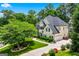Aerial view of a charming home with a well-manicured lawn and mature trees at 5833 Wembley Dr, Douglasville, GA 30135