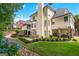 An expansive backyard featuring a patio, garden beds, and lush green lawn at 5833 Wembley Dr, Douglasville, GA 30135