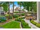 Picturesque backyard with lush landscaping, mature trees, and outdoor seating areas at 5833 Wembley Dr, Douglasville, GA 30135