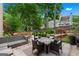 Lush backyard patio featuring a fire pit, comfortable seating, and mature trees for privacy at 5833 Wembley Dr, Douglasville, GA 30135