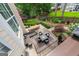 Beautifully landscaped backyard featuring multiple seating areas, including a fire pit and dining table at 5833 Wembley Dr, Douglasville, GA 30135