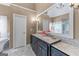 Modern bathroom featuring double vanity with marble countertops, and vanity lighting at 5833 Wembley Dr, Douglasville, GA 30135