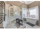 Modern bathroom featuring glass enclosed shower, soaking tub and tiled floors at 5833 Wembley Dr, Douglasville, GA 30135