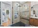 Modern shower featuring glass enclosure, shower head and hand held fixture, and a floating vanity at 5833 Wembley Dr, Douglasville, GA 30135