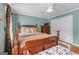 Comfortable bedroom with a ceiling fan, warm decor, and a decorative wooden four poster bed frame at 5833 Wembley Dr, Douglasville, GA 30135