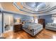 Spacious blue Primary bedroom with wood flooring, trey ceiling, and a sitting area at 5833 Wembley Dr, Douglasville, GA 30135