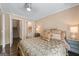 Serene bedroom with hardwood floors, a ceiling fan, neutral walls, and staircase access at 5833 Wembley Dr, Douglasville, GA 30135