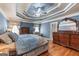 Spacious blue Primary bedroom with wood flooring, trey ceiling, and a wooden dresser at 5833 Wembley Dr, Douglasville, GA 30135