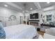 A well-lit bedroom featuring built-ins, fireplace, vanity, mounted TV, and neutral decor for a relaxing space at 5833 Wembley Dr, Douglasville, GA 30135