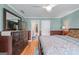 Comfortable bedroom featuring warm color walls, a ceiling fan, and wood flooring at 5833 Wembley Dr, Douglasville, GA 30135