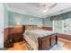 Comfortable bedroom featuring warm color walls, a ceiling fan, and wood flooring at 5833 Wembley Dr, Douglasville, GA 30135