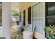 Relaxing covered porch with outdoor seating, and a view of trees at 5833 Wembley Dr, Douglasville, GA 30135