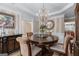 Formal dining room features an elegant chandelier, striped walls and round table at 5833 Wembley Dr, Douglasville, GA 30135