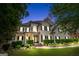 Exterior facade of home at twilight features manicured lawn and covered front porch at 5833 Wembley Dr, Douglasville, GA 30135