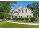 Two-story home with black shutters, manicured lawn and lovely, lush landscaping at 5833 Wembley Dr, Douglasville, GA 30135
