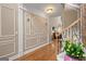 View of foyer and staircase features decorative trim and hardwood flooring at 5833 Wembley Dr, Douglasville, GA 30135