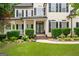 Charming two-story home with covered porch, manicured bushes and brick walkway at 5833 Wembley Dr, Douglasville, GA 30135