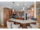 Well-lit kitchen with custom wood cabinets, granite countertops, breakfast bar, and pendant lighting at 5833 Wembley Dr, Douglasville, GA 30135