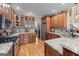 Gourmet kitchen with granite countertops, stainless steel appliances, and rich wood cabinetry at 5833 Wembley Dr, Douglasville, GA 30135