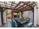 Outdoor seating area with an ornate table, comfortable seating, string lights, and a covered pergola at 5833 Wembley Dr, Douglasville, GA 30135