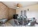 Charming screened patio with comfortable seating, ceiling fan, and privacy brick wall at 5833 Wembley Dr, Douglasville, GA 30135