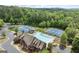 Aerial view of community amenities including pool, tennis courts, clubhouse, and parking at 6248 Sunshine Cove Ln, Buford, GA 30518
