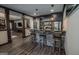 Chic bar area with stone accents, dark cabinetry, and modern lighting at 6248 Sunshine Cove Ln, Buford, GA 30518